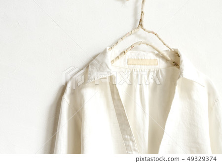 一件白色大麻女襯衫的上身和白色背景在掛衣架的 49329374