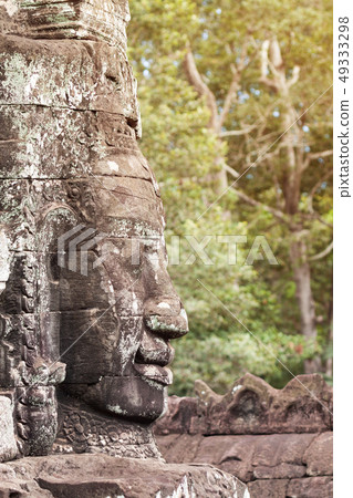 Massive stone carving faces of Bayon temple in Massive stone carving faces of Bayon temple in 49333298