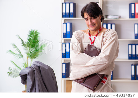 Crazy young man in straitjacket at the office Crazy young man in straitjacket at the office 49334057