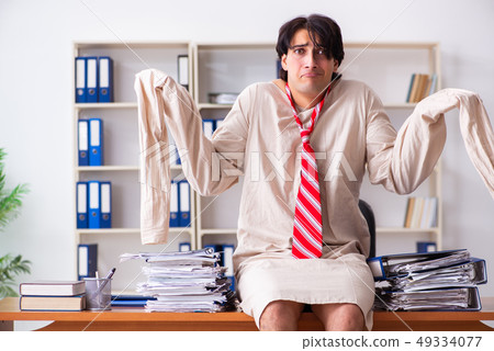 Crazy young man in straitjacket at the office  49334077