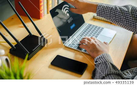 Young man Connecting router wifi On smartphone  49335139