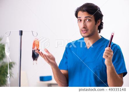 Young male doctor in blood transfusion concept  49335148