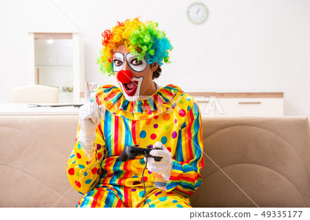 Male clown preparing for perfomance at home Male clown preparing for perfomance at home 49335177