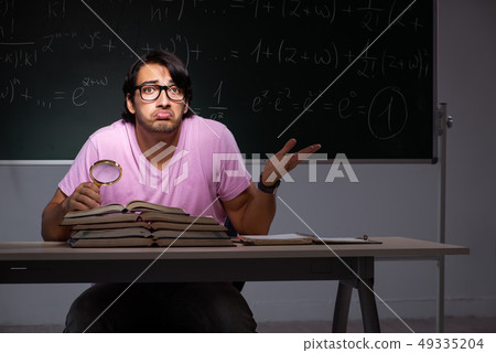 Young male student sitting in classroom Young male student sitting in classroom 49335204