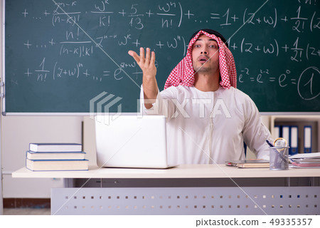 Arab teacher in front of chalkboard Arab teacher in front of chalkboard 49335357