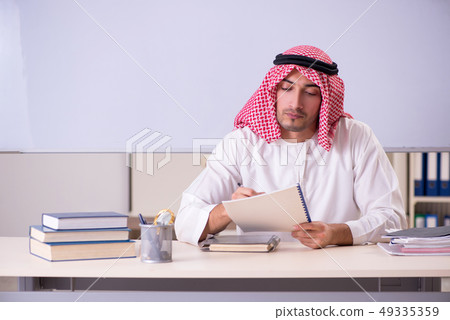 Arab teacher in front of whiteboard Arab teacher in front of whiteboard 49335359