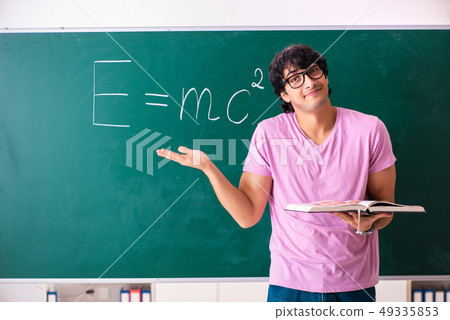 Young male physic standing in front of the green board Young male physic standing in front of the green board 49335853