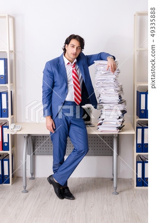 Young businessman employee unhappy with excessive work Young businessman employee unhappy with excessive work 49335888