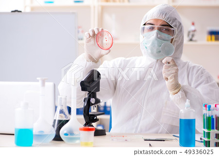 Young handsome chemist working in the lab Young handsome chemist working in the lab 49336025