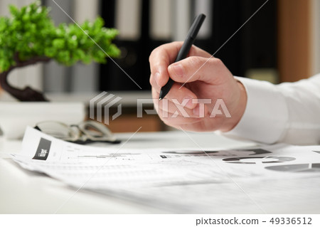 Businessman working in office and calculating Businessman working in office and calculating 49336512