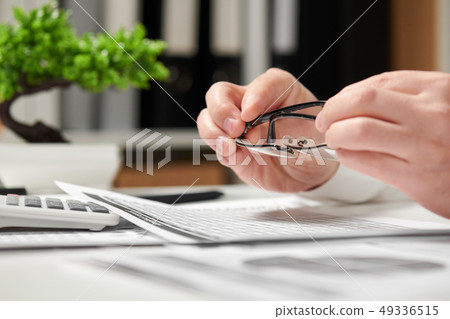 Businessman working in office and calculating Businessman working in office and calculating 49336515