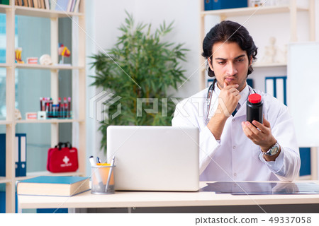 Young handsome doctor working in clinic  49337058
