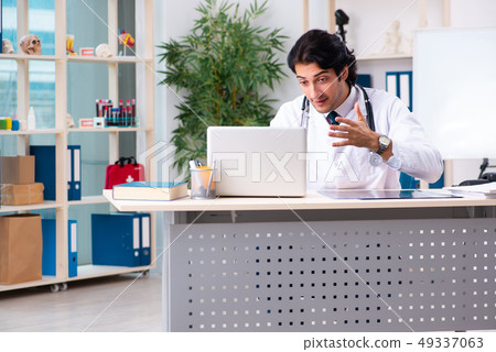 Young handsome doctor in telemedicine concept  49337063