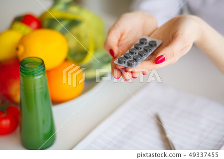 Diet. Female Nutritionist Holding Blisters of Pills Diet. Female Nutritionist Holding Blisters of Pills 49337455