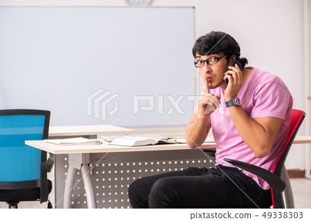 Young male student sitting in the class Young male student sitting in the class 49338303