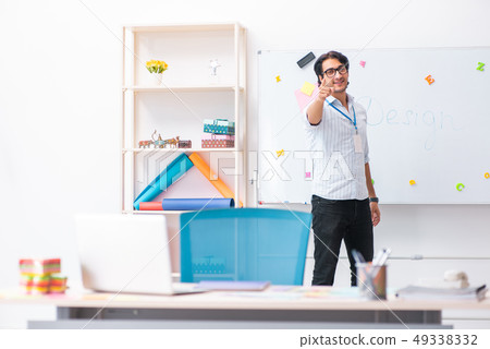 Young handsome male designer working in the office Young handsome male designer working in the office 49338332