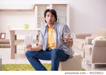 Young handsome man repairing chair at home  49338922