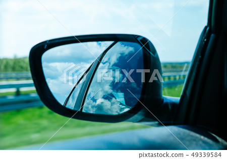 Landscape in the sideview mirror of a car 49339584