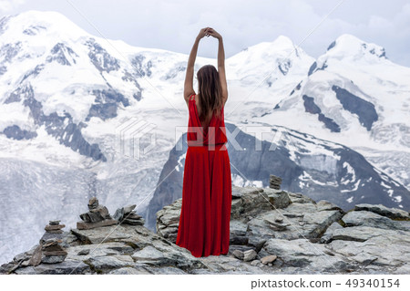 woman in long red dress on background of glacier 49340154