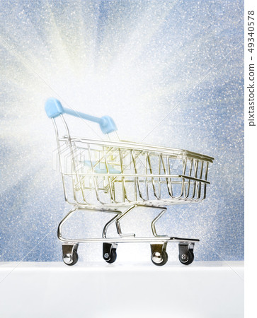 Trolley for shopping on a pedestal on a winter blue background with a glow. Best Buyer, Best Buy. 49340578