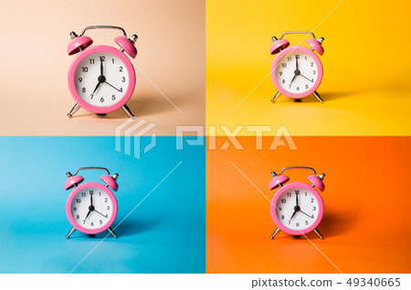 Pink alarm clock on the four different backgrounds with a shadow. Pink alarm clock on the four different backgrounds with a shadow. 49340665