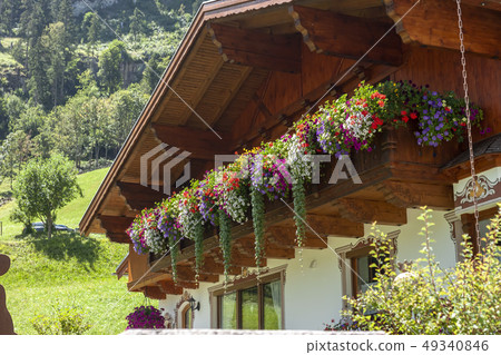 traditional chalet decorated with flowers summer time 49340846