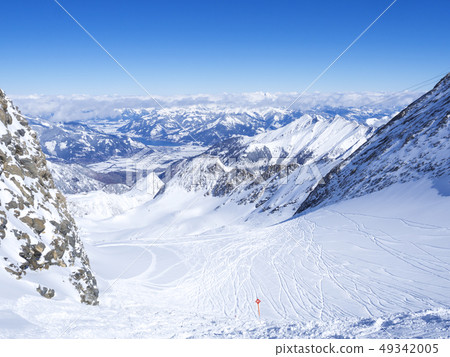 Winter landscape with free ride piste and view on snow covered slopes and blue sky, with Aerial view Winter landscape with free ride piste and view on snow covered slopes and blue sky, with Aerial view 49342005