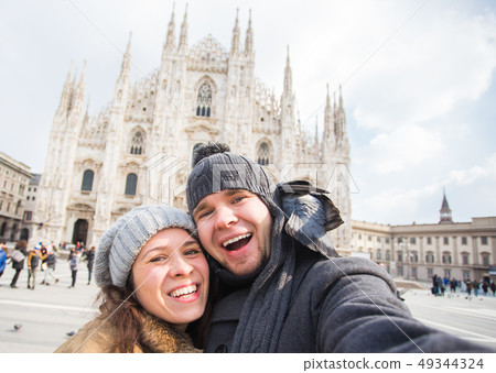 Travel, Italy and funny couple concept - Happy tourists taking a self portrait with pigeons in front 49344324