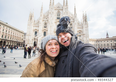 Travel, Italy and funny couple concept - Happy tourists taking a self portrait with pigeons in front Travel, Italy and funny couple concept - Happy tourists taking a self portrait with pigeons in front 49344327