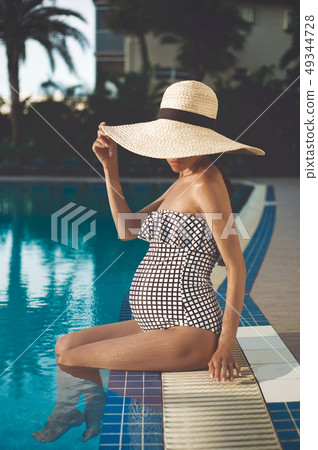 Beautiful pregnant woman in swimming pool 49344728