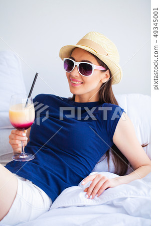 Vacation. Woman Who is Preparing for Rest. Young Beautiful Girl Sits on the Bed. Portrait of a 49345001