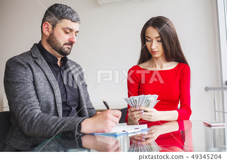 Business Woman Gives Money to Men. Woman Dressed in Red Dress Gives Bribe. Business Man In Gray 49345204