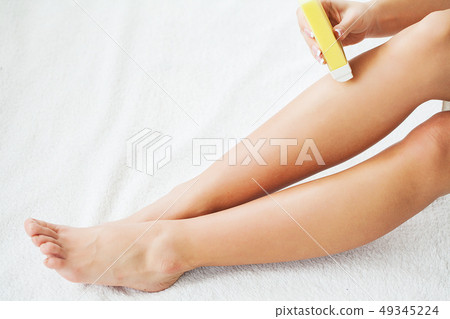 Waxing. Beautician Waxing Woman's Leg In Spa Salon Waxing. Beautician Waxing Woman's Leg In Spa Salon 49345224