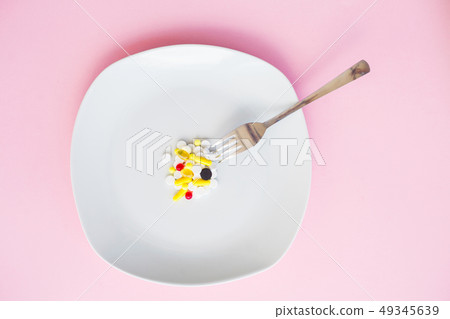 Close up of pills on plate. Dietary supplements. Variety pills. Vitamin capsules on plate Close up of pills on plate. Dietary supplements. Variety pills. Vitamin capsules on plate 49345639