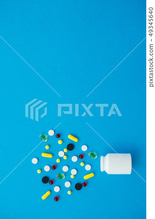 Pharmacy and pills. Medicines, Supplements and Drugs in a Bottle on Blue Background Pharmacy and pills. Medicines, Supplements and Drugs in a Bottle on Blue Background 49345640