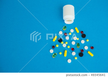 Pharmacy and pills. Medicines, Supplements and Drugs in a Bottle on Blue Background Pharmacy and pills. Medicines, Supplements and Drugs in a Bottle on Blue Background 49345641