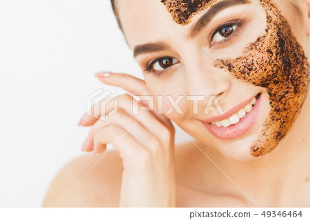 Face Skincare. Young Charming Girl Makes a Black Charcoal Mask on Her Face Face Skincare. Young Charming Girl Makes a Black Charcoal Mask on Her Face 49346464