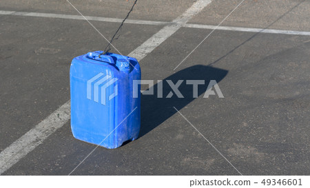 Blue canister on the pavement in sunny day 49346601