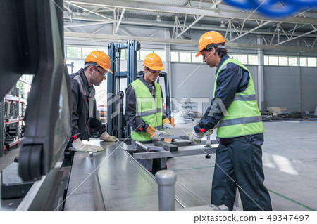 Team of workers in CNC factory 49347497
