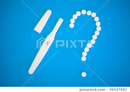 Pregnancy planning concep. Pregnancy test positive with two stripes and contraceptive pill on blue 49347883