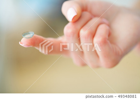 Vision Contact Lenses. Beautiful Woman Holds Finger on a Contact Lens, Closeup 49348081