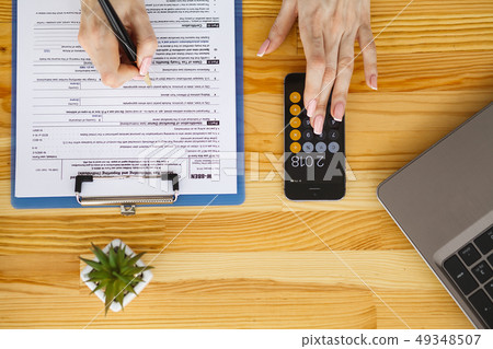 Business analysis - woman working with financial data charts at office Business analysis - woman working with financial data charts at office 49348507