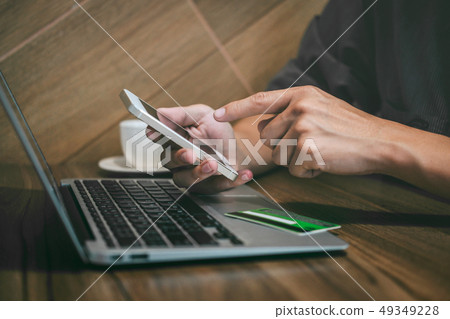 Businessman holding credit card and using 49349228