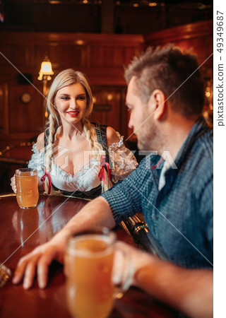 Drunk man with beer mug and waitress at counter 49349687