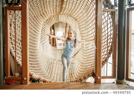 Girls climbing the rope net, children game center 49349795