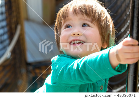 Happy toddler boy playing Happy toddler boy playing 49350071