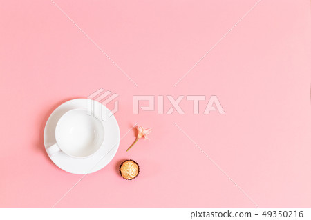 Cup, candy and flower on living coral background Cup, candy and flower on living coral background 49350216