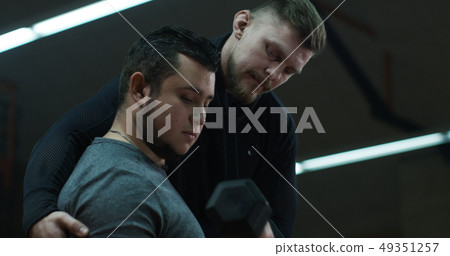 Trainer yelling at weightlifting young man Trainer yelling at weightlifting young man 49351257