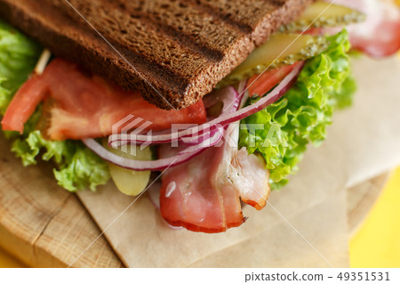 Closeup juicy sandwich with grilled dark bread and 49351531