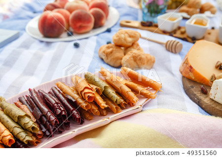 Summer picnic blanket with tasty food and snacks Summer picnic blanket with tasty food and snacks 49351560